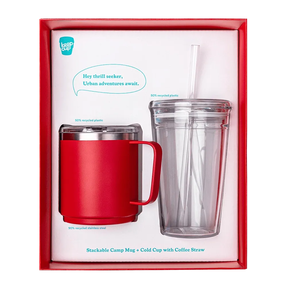 KeepCup Urban Adventurer gift set in Poppy, featuring a red stainless steel stackable camp mug and a clear double-walled cold cup with straw, displayed in red presentation packaging with product callouts noting recycled materials.
