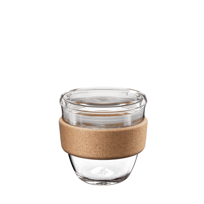 KeepCup Brew Cork Quicksip S 8oz reusable coffee cup shown from a front angle, featuring a clear tempered glass body, natural cork band sleeve, and transparent lid with sipper opening.