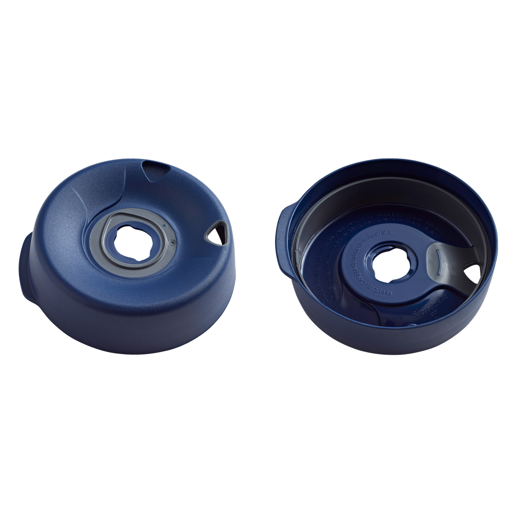 Navy Splashproof Lid Base shown from two angles: the top view displaying the hexagonal centre opening with grey silicone seal and ventilation slots, and the underside view revealing the internal structure and moulded branding text.