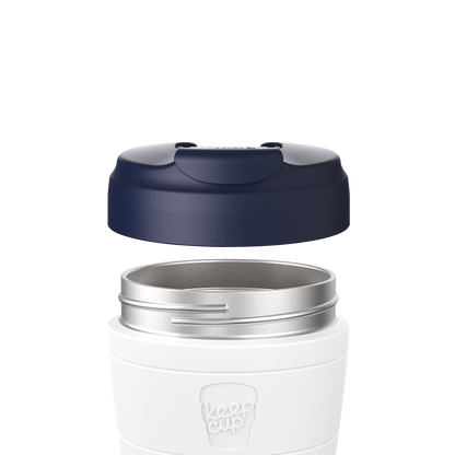 Navy Commuter Flip Lid shown lifted above a white KeepCup with stainless steel rim, demonstrating how the lid attaches to the cup in an exploded product view.