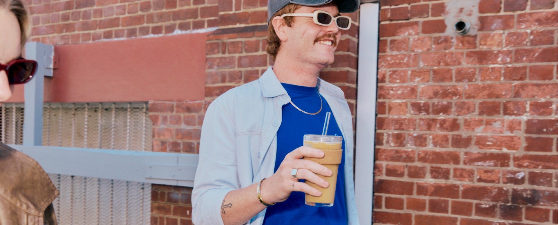 Man holding KeepCup Cold Cup Cork in 16oz with iced coffee