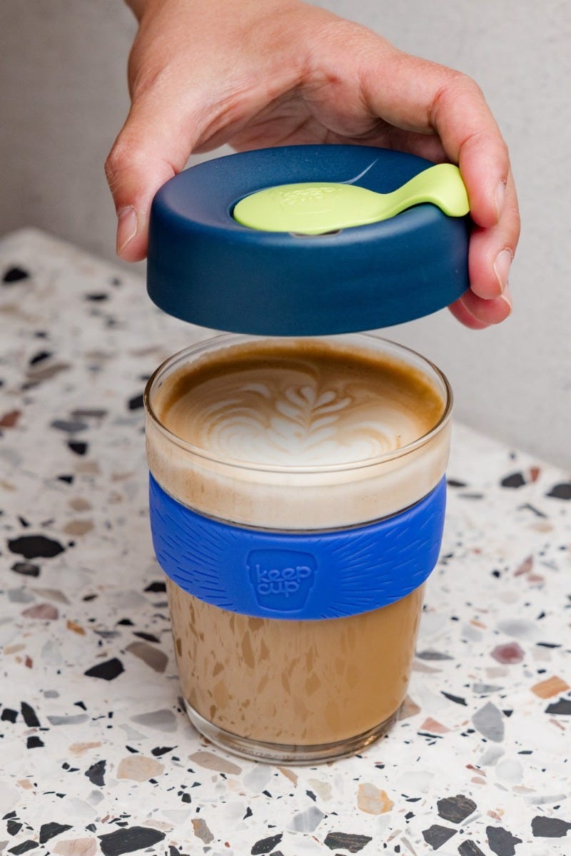 Woman holding KeepCup Brew Glass 12oz with coffee