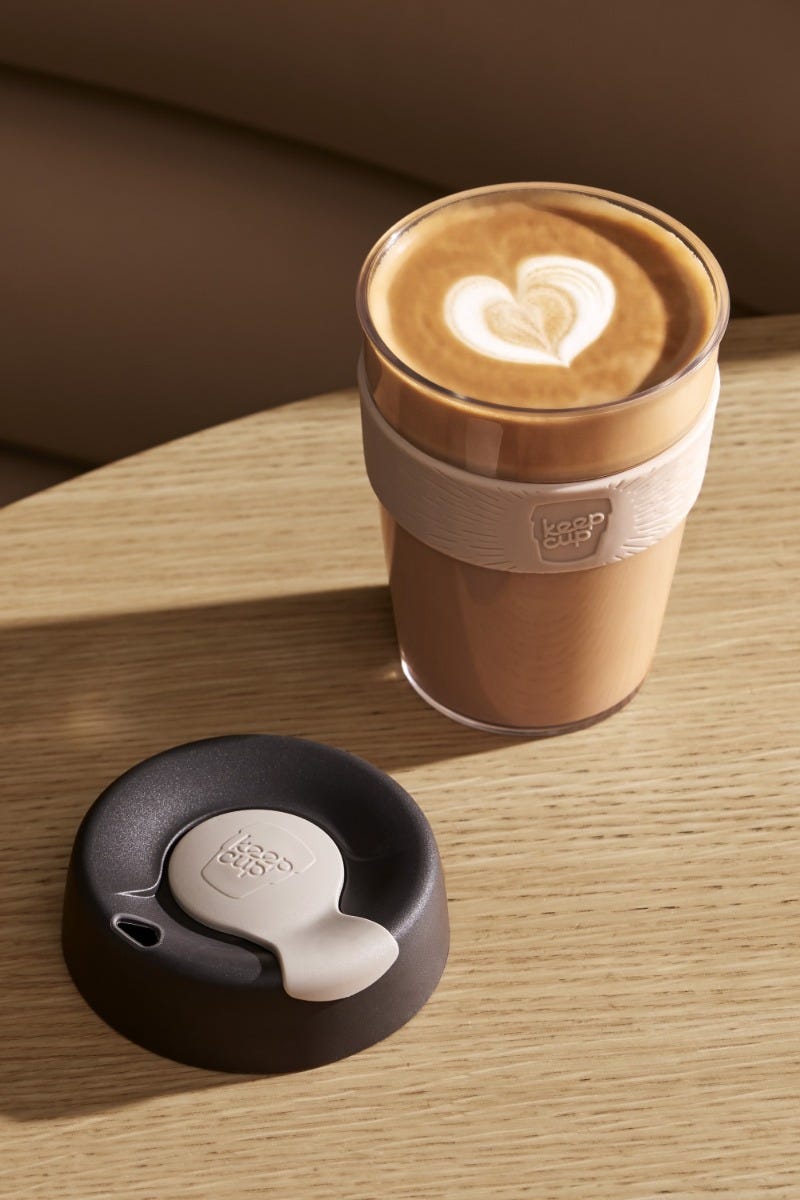 KeepCup Original Clear M 12oz sitting on table with coffee